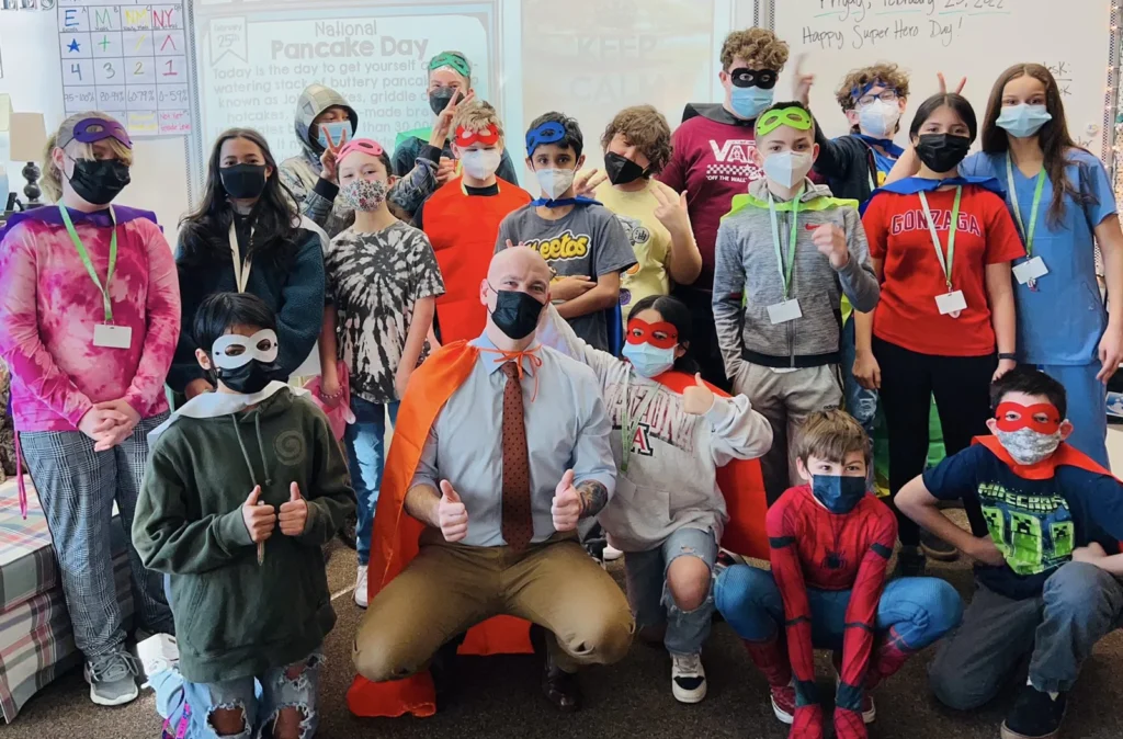 Michael Fuller, Founder of Underdog Law Volunteering with a bunch of kids in costumes.